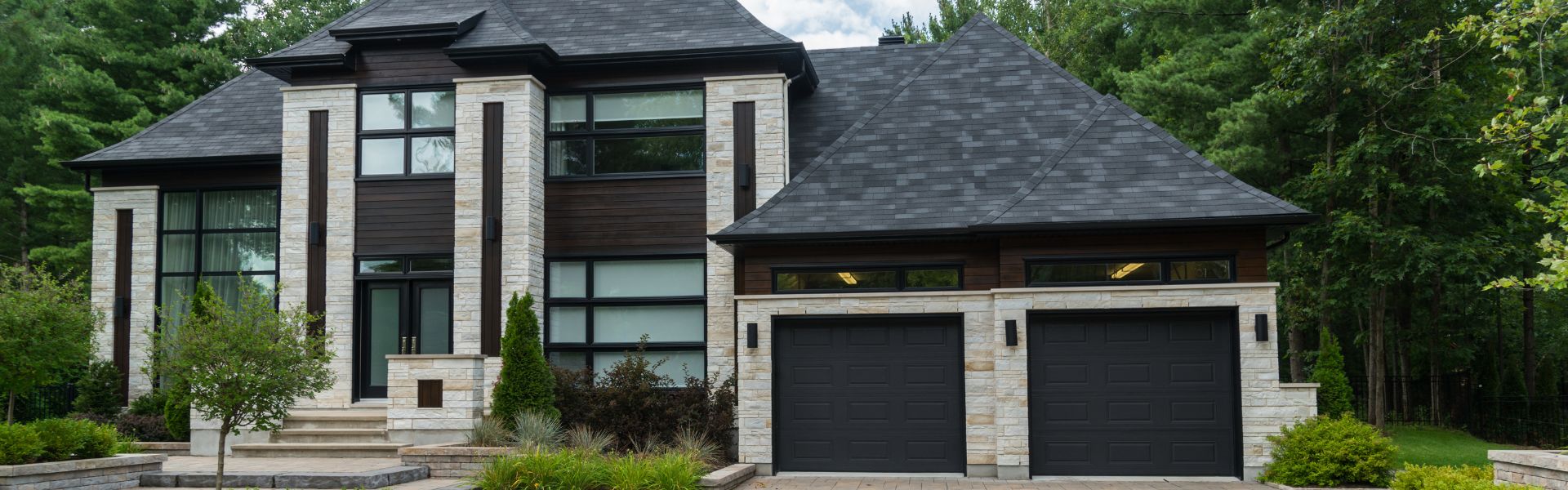 Modern custom-built home exterior by GreenRock Builders, featuring clean lines and large windows